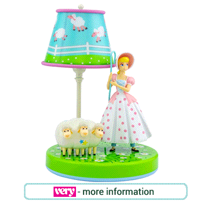 Children's bedside lamp. Figures of Mary with 3 lambs, green base and blue lamp shade featuring more sheep.